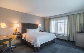 King bed with work desk at Hampton Inn Chicago North/Loyola Station.