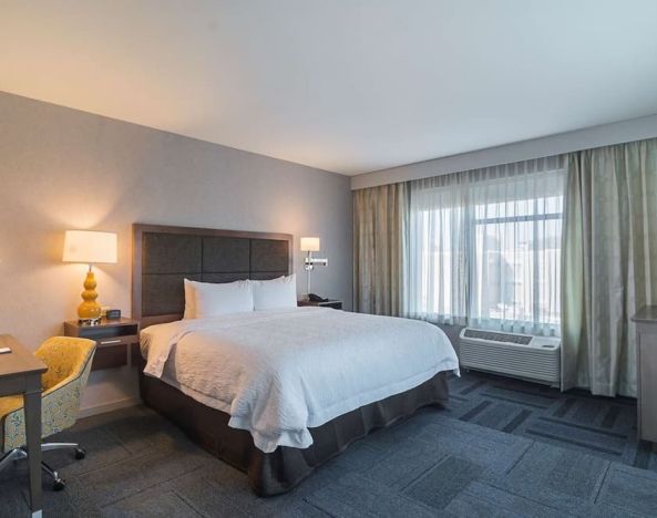 King bed with work desk at Hampton Inn Chicago North/Loyola Station.