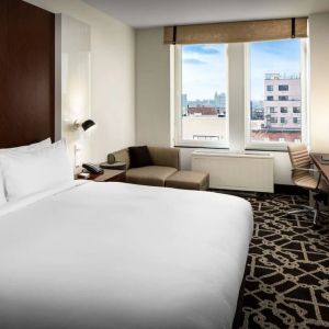 King-sized bed with work desk at Hilton Brooklyn New York.