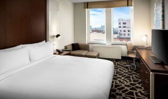 King-sized bed with work desk at Hilton Brooklyn New York.