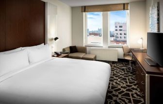 King-sized bed with work desk at Hilton Brooklyn New York.