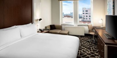 King-sized bed with work desk at Hilton Brooklyn New York.