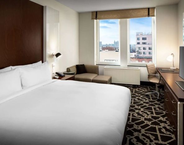 King-sized bed with work desk at Hilton Brooklyn New York.