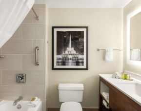 Guest bathroom with shower and tub at DoubleTree By Hilton Orlando Downtown.
