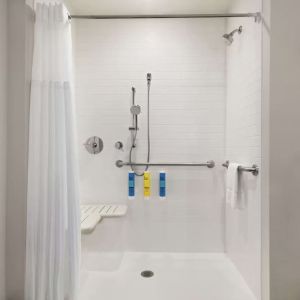 Guest bathroom with shower at Tru By Hilton Milwaukee Brookfield.