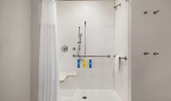 Guest bathroom with shower at Tru By Hilton Milwaukee Brookfield.