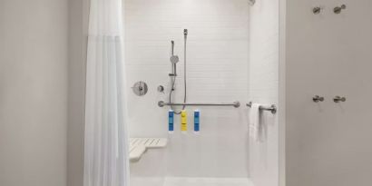 Guest bathroom with shower at Tru By Hilton Milwaukee Brookfield.