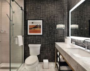 Guest bathroom with shower at The Slate Denver, Tapestry Collection By Hilton.