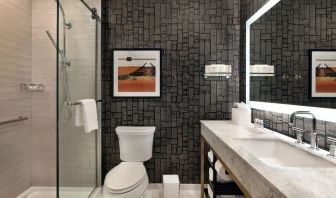 Guest bathroom with shower at The Slate Denver, Tapestry Collection By Hilton.