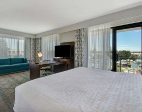 Day use room with work desk, sofa and balcony at Hampton Inn & Suites Sunnyvale Silicon Valley.