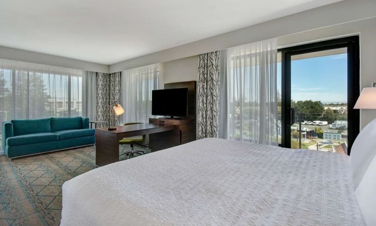 Day use room with work desk, sofa and balcony at Hampton Inn & Suites Sunnyvale Silicon Valley.