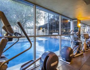 Fitness center overlooking the pool at Hilton Dallas Lincoln Centre.