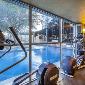 Fitness center overlooking the pool at Hilton Dallas Lincoln Centre.