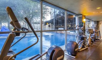 Fitness center overlooking the pool at Hilton Dallas Lincoln Centre.