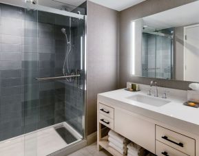 Guest bathroom with shower at Hilton Dallas Lincoln Centre.