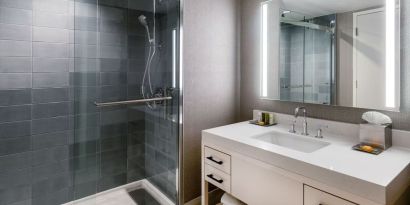 Guest bathroom with shower at Hilton Dallas Lincoln Centre.