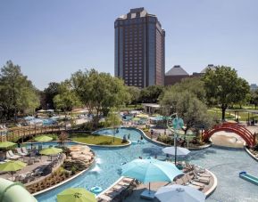 Lazy river, waterslide, and sun loungers available around the outdoor pool at Hilton Anatole.