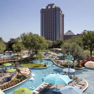 Lazy river, waterslide, and sun loungers available around the outdoor pool at Hilton Anatole.