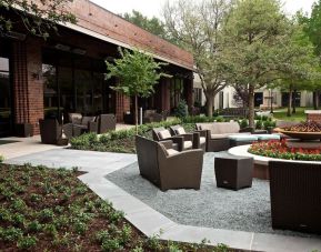 Firepit surrounded by outdoor furniture at Hilton Anatole.