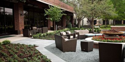 Firepit surrounded by outdoor furniture at Hilton Anatole.