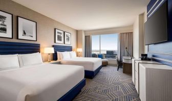 Day use room with two beds and workdesk at Hilton BNA Nashville Airport Terminal.
