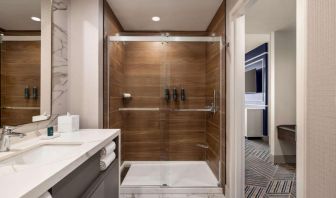 Private guest bathroom with shower at Hilton BNA Nashville Airport Terminal.
