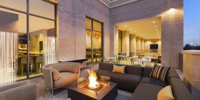 Hotel terrace with lounge area and fireplace at Hilton Garden Inn Nashville West End Avenue.