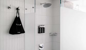 Private guest bathroom with shower and free toiletries at Arlo SoHo.