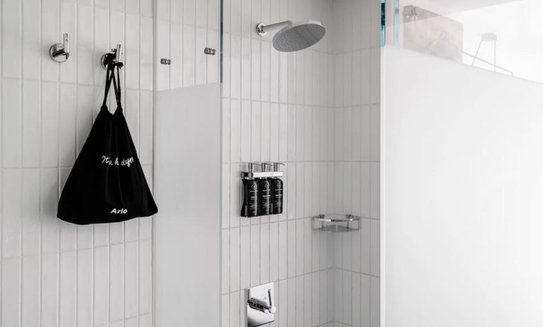 Private guest bathroom with shower and free toiletries at Arlo SoHo.