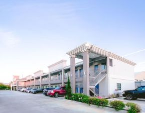 Hotel exterior and parking area at Express Inn - Spring.