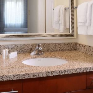 Private guest bathroom with shower and free toiletries at Sonesta ES Suites Dallas Medical Market Center.