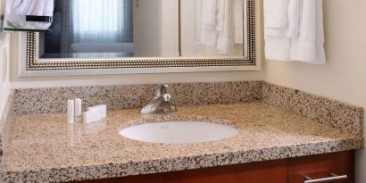 Private guest bathroom with shower and free toiletries at Sonesta ES Suites Dallas Medical Market Center.