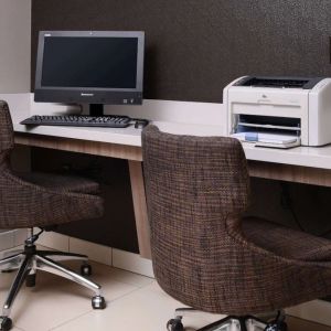 Business center with computer, printer and comfortable seating at Sonesta ES Suites Dallas Medical Market Center.