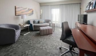 Day use suite's workspace and lounge area at Sonesta Select Dallas Central Expressway.