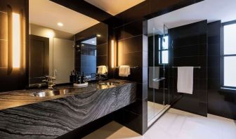 Private guest bathroom with shower and free toiletries at The Benjamin Royal Sonesta New York.