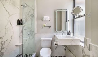 Private guest bathroom with shower at The Benjamin Royal Sonesta New York.