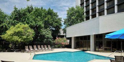 Outdoor pool with lounge chairs at Sonesta Nashville Airport.