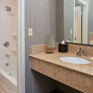 Private guest bathroom with shower and free toiletries at Sonesta Select Indianapolis Carmel.