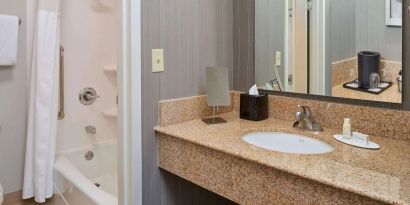 Private guest bathroom with shower and free toiletries at Sonesta Select Indianapolis Carmel.