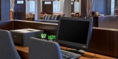 Business center with computer, printer and ergonomic chairs at Sonesta Select Indianapolis Carmel.