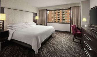 King bedroom with work desk at Embassy Suites By Hilton Crystal City-National Airport.