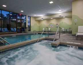 Relaxing indoor pool with lounge chairs at Sonesta Milwaukee West Wauwatosa.