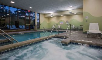 Relaxing indoor pool with lounge chairs at Sonesta Milwaukee West Wauwatosa.