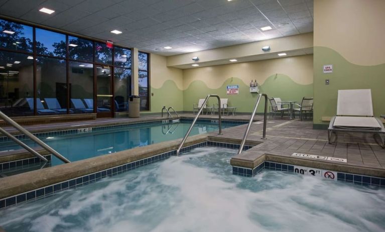 Relaxing indoor pool with lounge chairs at Sonesta Milwaukee West Wauwatosa.