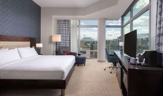 Bright king room with work station and a view of the city at Hilton Garden Inn Washington DC/Georgetown Area.
