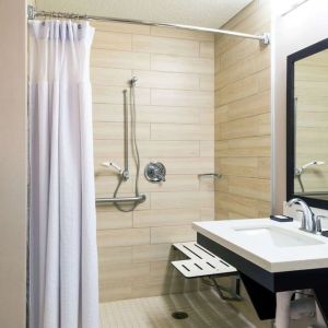 Accessible private guest bathroom with shower at Sonesta Atlanta Airport North.