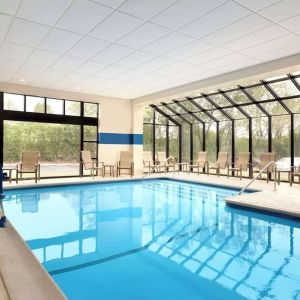 Indoor pool with lounge chairs at DoubleTree By Hilton Hartford - Bradley Airport.