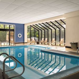 Indoor heated pool with lounge chairs at DoubleTree By Hilton Hartford - Bradley Airport.