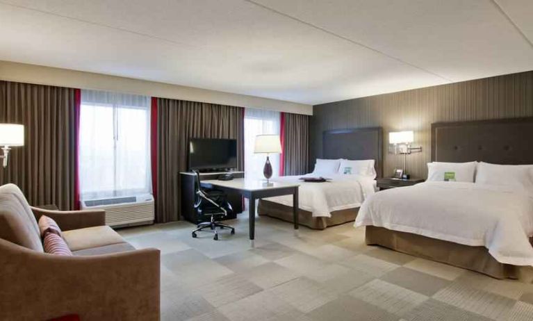 Comfortable room with 2 queen size beds, TV and working station at the Hampton Inn & Suites by Hilton Toronto Markham.