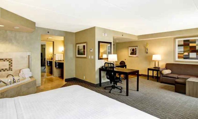 Comfortable king bedroom with whirlpool, working station and living area at the Homewood Suites by Hilton Toronto-Markham.